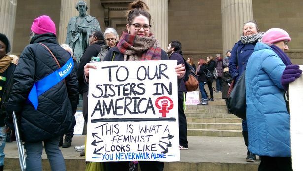 'To our sisters in America, this is what a feminist looks like. You never walk alone' banner